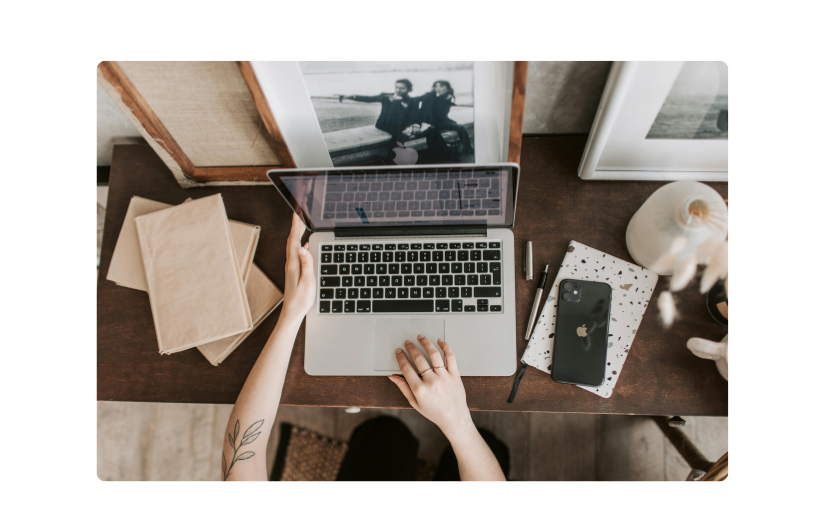 Person working on a laptop in a cozy home office, optimizing content for better search engine visibility in eCommerce.